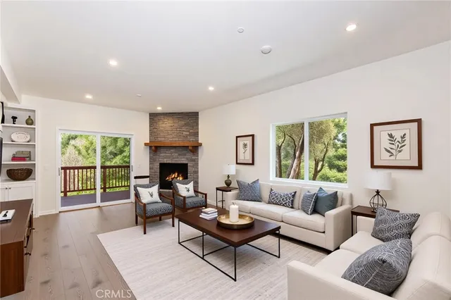 a living room with furniture couches and a fireplace