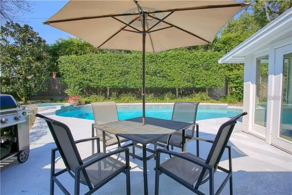 a patio table and chairs with an umbrella
