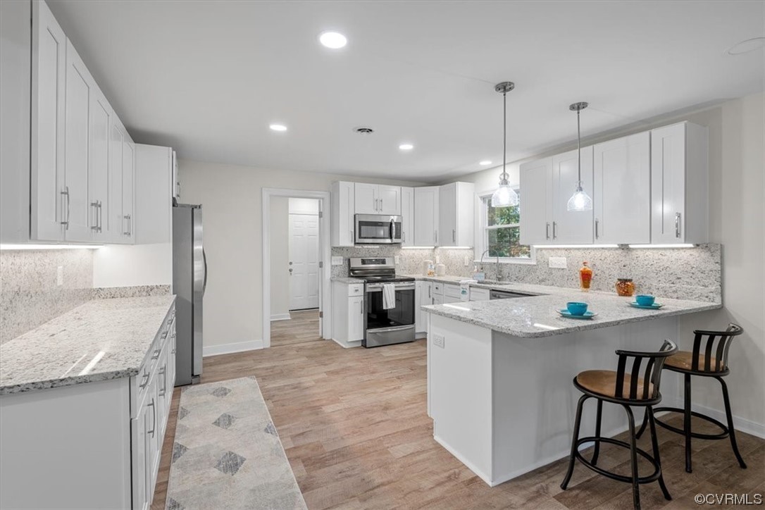 13109 Bluemont Road Chester, VA 23831 - Photo 17 of 50 a kitchen with stainless steel appliances granite countertop a stove top oven a refrigerator a sink and a island