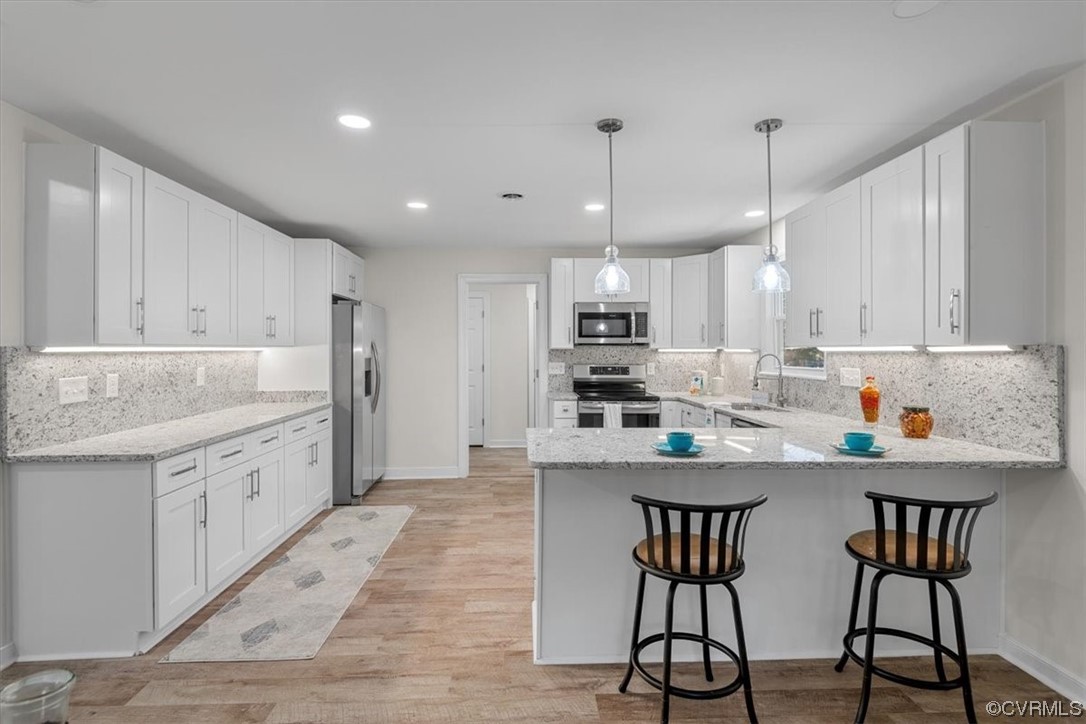 13109 Bluemont Road Chester, VA 23831 - Photo 18 of 50 a kitchen with stainless steel appliances kitchen island granite countertop a table chairs sink and cabinets