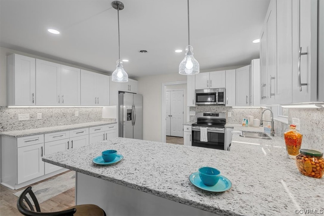 13109 Bluemont Road Chester, VA 23831 - Photo 19 of 50 a kitchen with stainless steel appliances granite countertop a sink stove and refrigerator