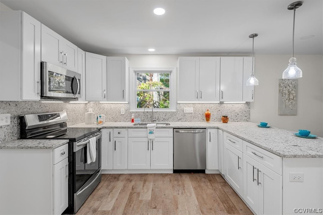 13109 Bluemont Road Chester, VA 23831 - Photo 20 of 50 a kitchen with granite countertop white cabinets a sink a window and appliances