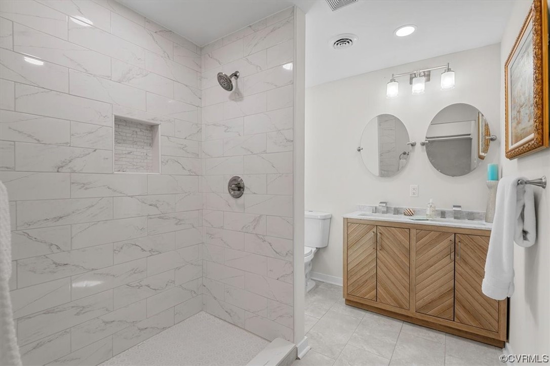 13109 Bluemont Road Chester, VA 23831 - Photo 35 of 50 a bathroom with a double vanity sink a mirror and shower