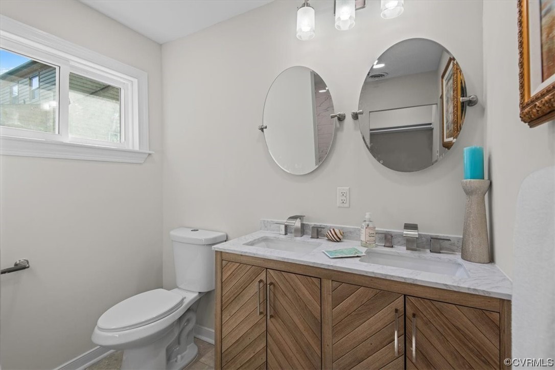 13109 Bluemont Road Chester, VA 23831 - Photo 36 of 50 a bathroom with a granite countertop toilet sink and mirror