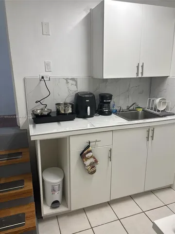 a kitchen with stainless steel appliances a sink and cabinets