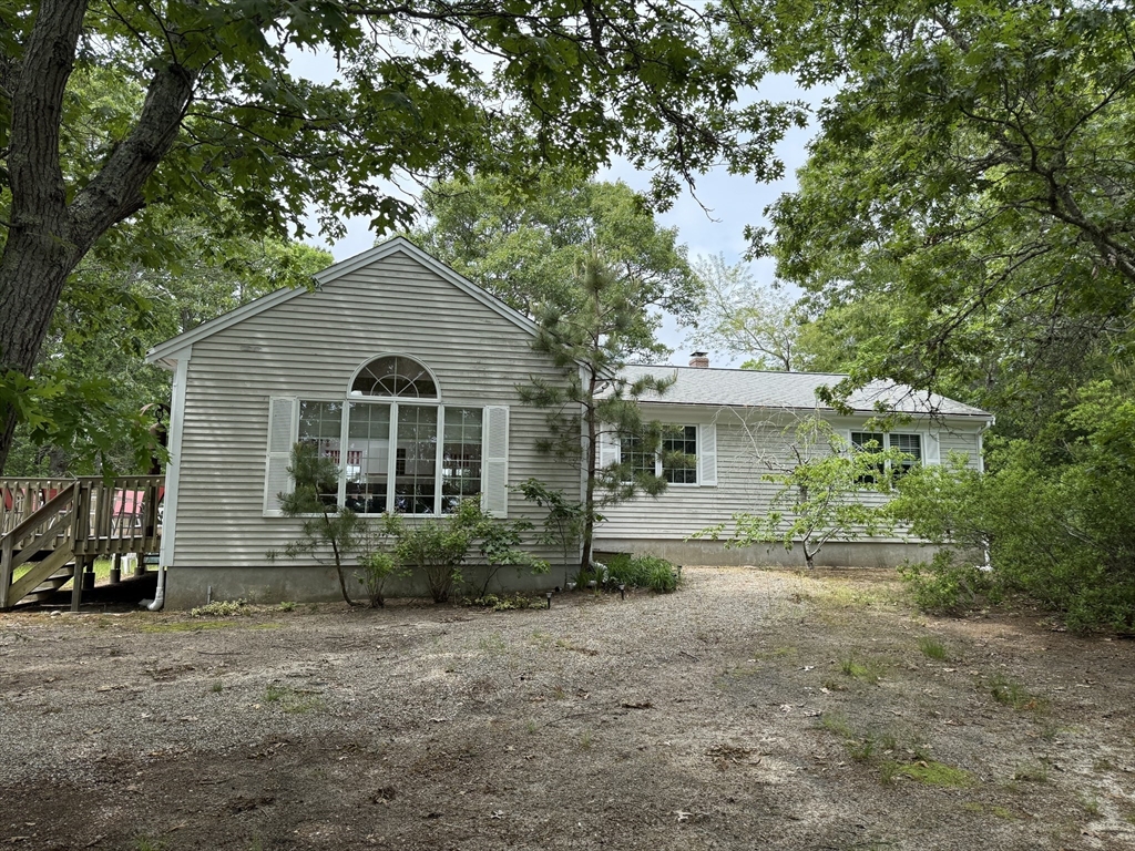183 Monomoscoy Road Mashpee, MA 02649 - Photo 2 of 22 a front view of a house with garden