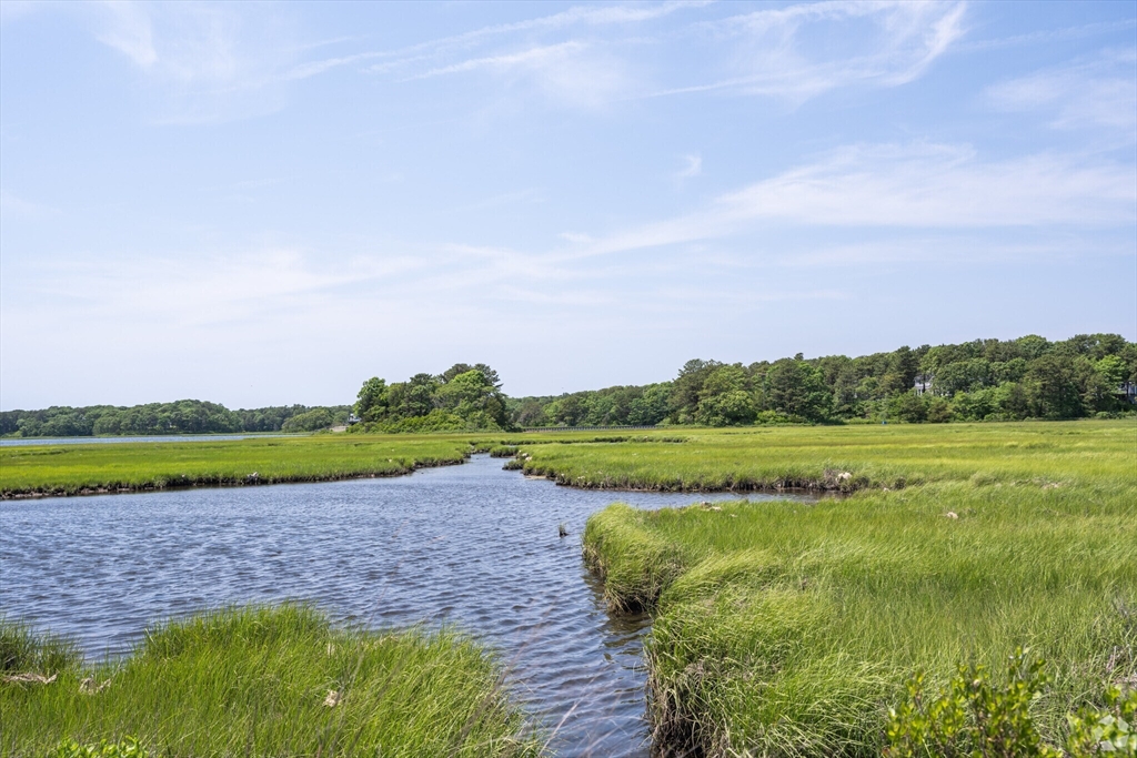 183 Monomoscoy Road Mashpee, MA 02649 - Photo 22 of 22 a view of a lake with a big yard