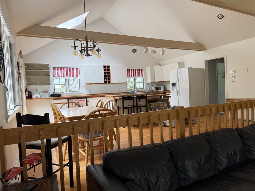 183 Monomoscoy Road Mashpee, MA 02649 - Photo 4 of 22 a living room with furniture and a dining table