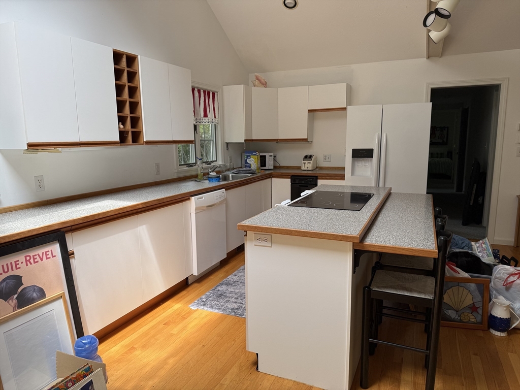 183 Monomoscoy Road Mashpee, MA 02649 - Photo 7 of 22 a kitchen that has a sink a stove and chairs