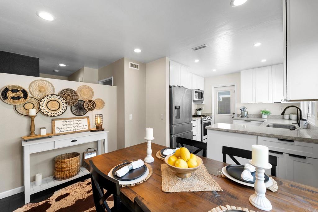 333 Sunflower Escondido, CA 92026 - Photo 11 of 36 a kitchen with stainless steel appliances kitchen island granite countertop a sink and cabinets