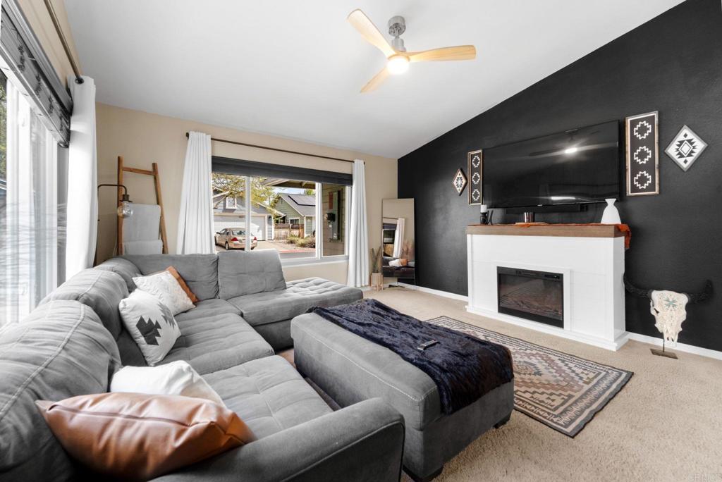 333 Sunflower Escondido, CA 92026 - Photo 14 of 36 a living room with furniture a flat screen tv and a fireplace