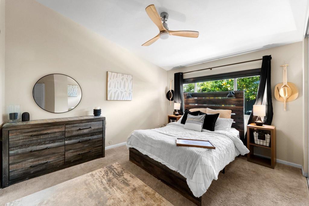 333 Sunflower Escondido, CA 92026 - Photo 18 of 36 a bedroom with a bed a mirror on dresser and a large window