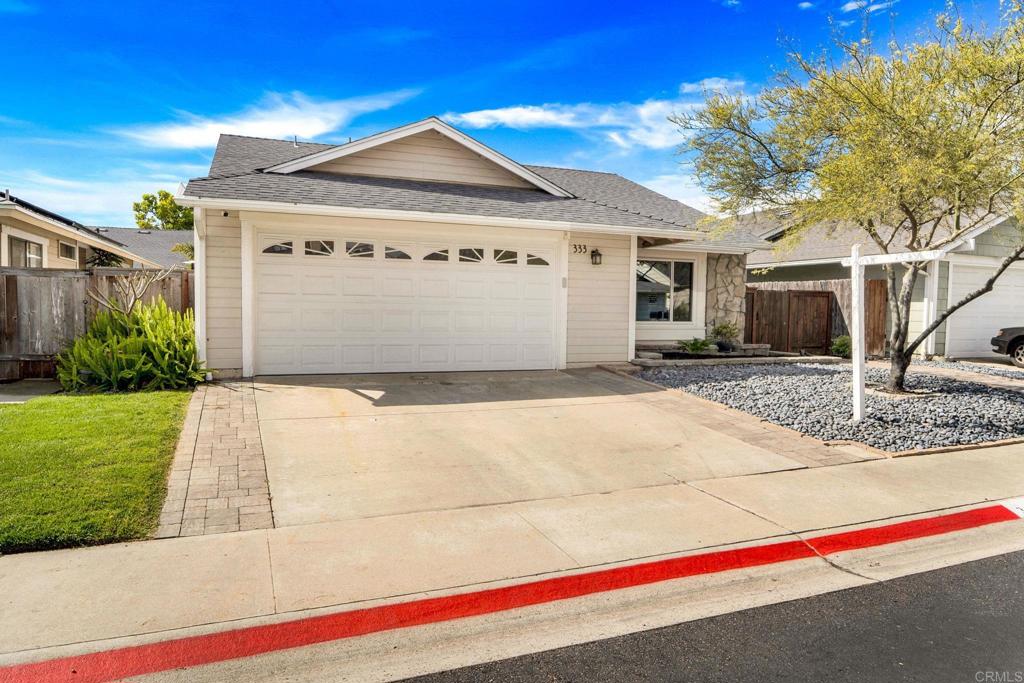 333 Sunflower Escondido, CA 92026 - Photo 3 of 36 a front view of a house with a yard and garage