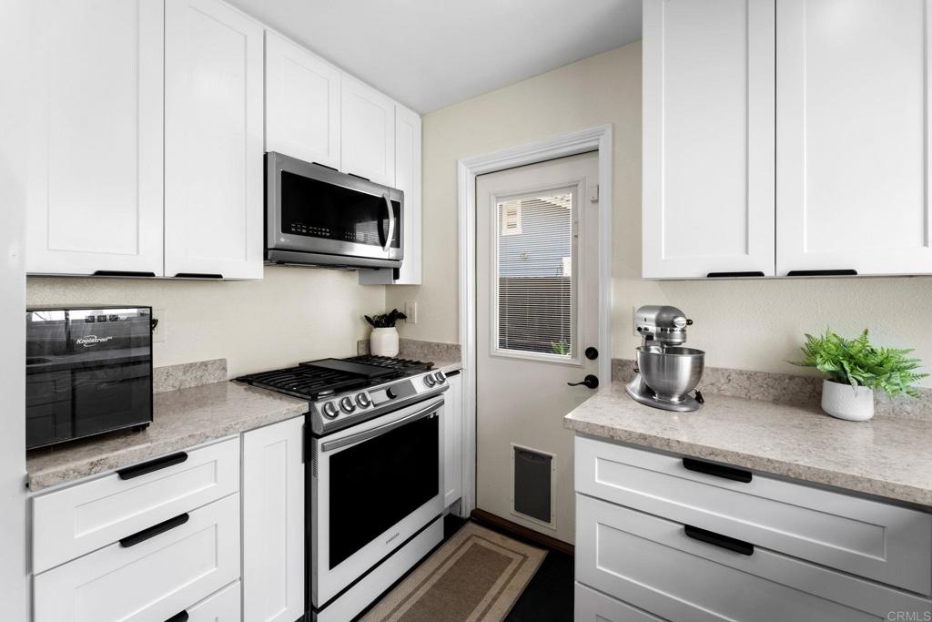 333 Sunflower Escondido, CA 92026 - Photo 7 of 36 a kitchen with stainless steel appliances a stove microwave and sink