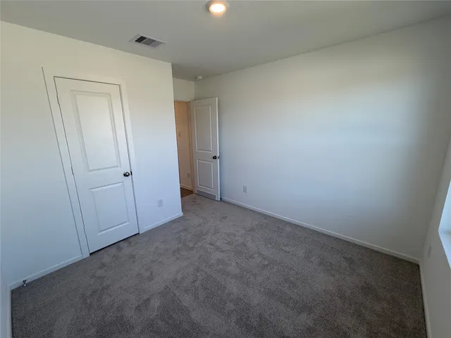 an empty room with closet area