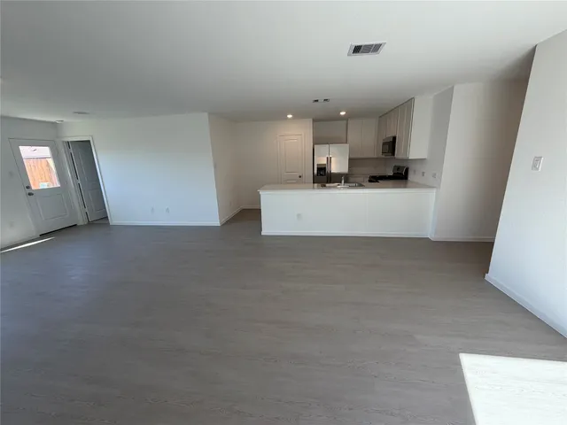 a view of kitchen with stainless steel appliances cabinets