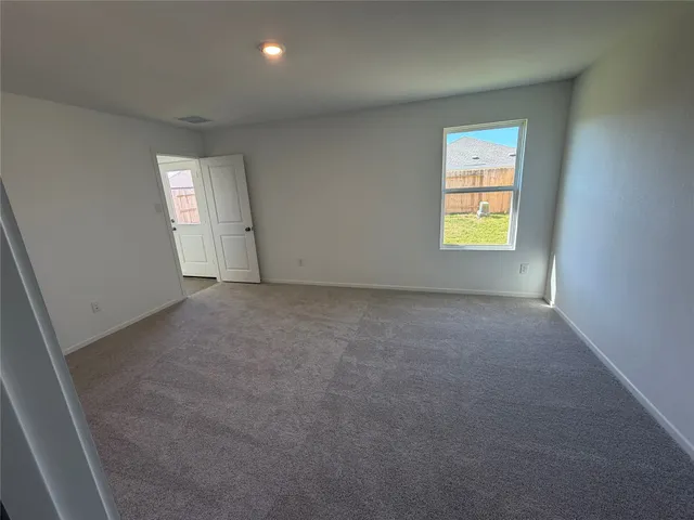an empty room with a window and a fireplace