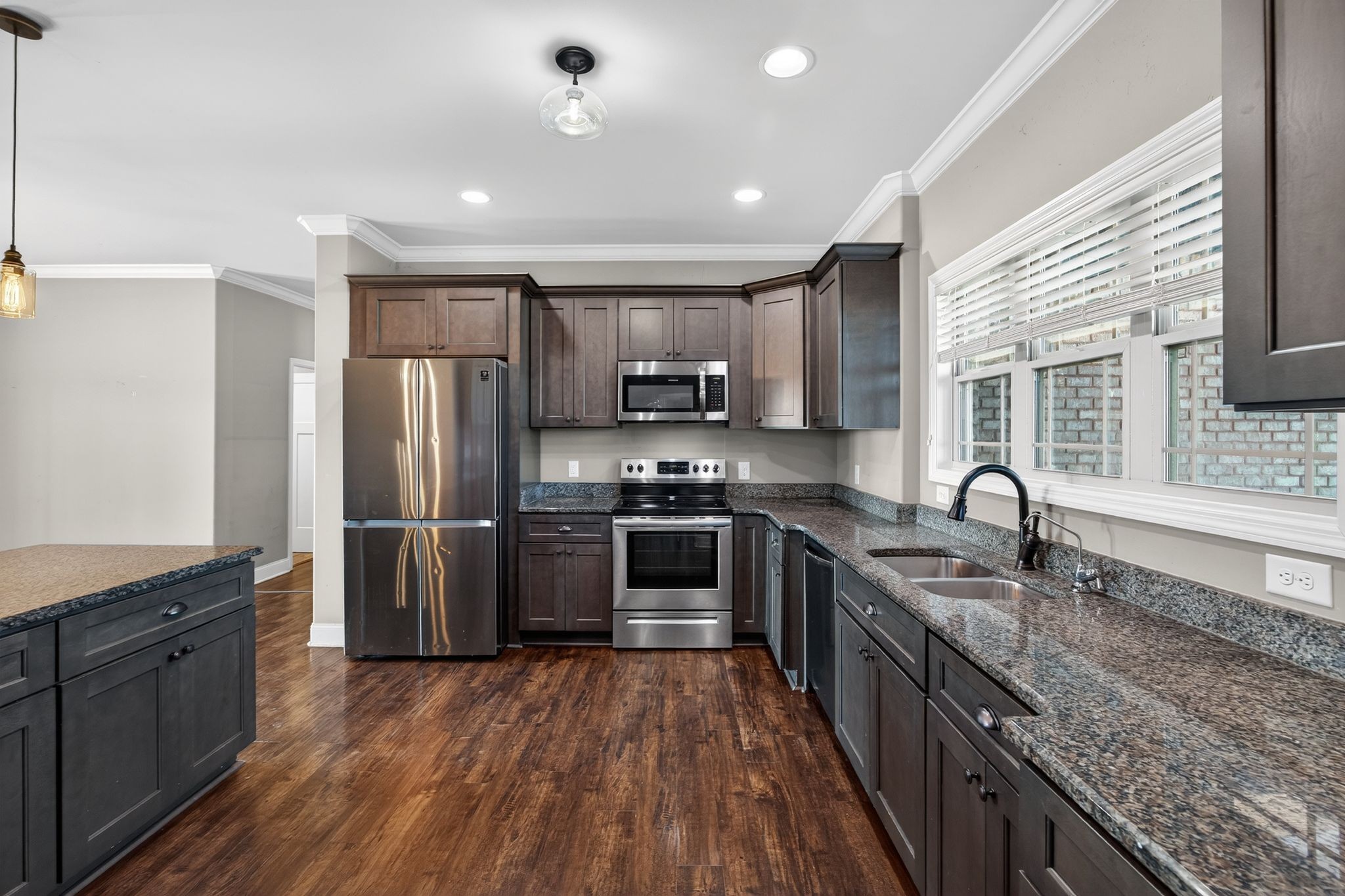 1347 Neil Road Chapel Hill, TN 37034 - Photo 14 of 36 a kitchen with granite countertop a refrigerator a sink a stove top oven a counter space and cabinets