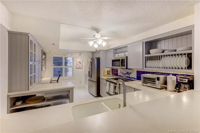 a living room with furniture a flat screen tv and white walls