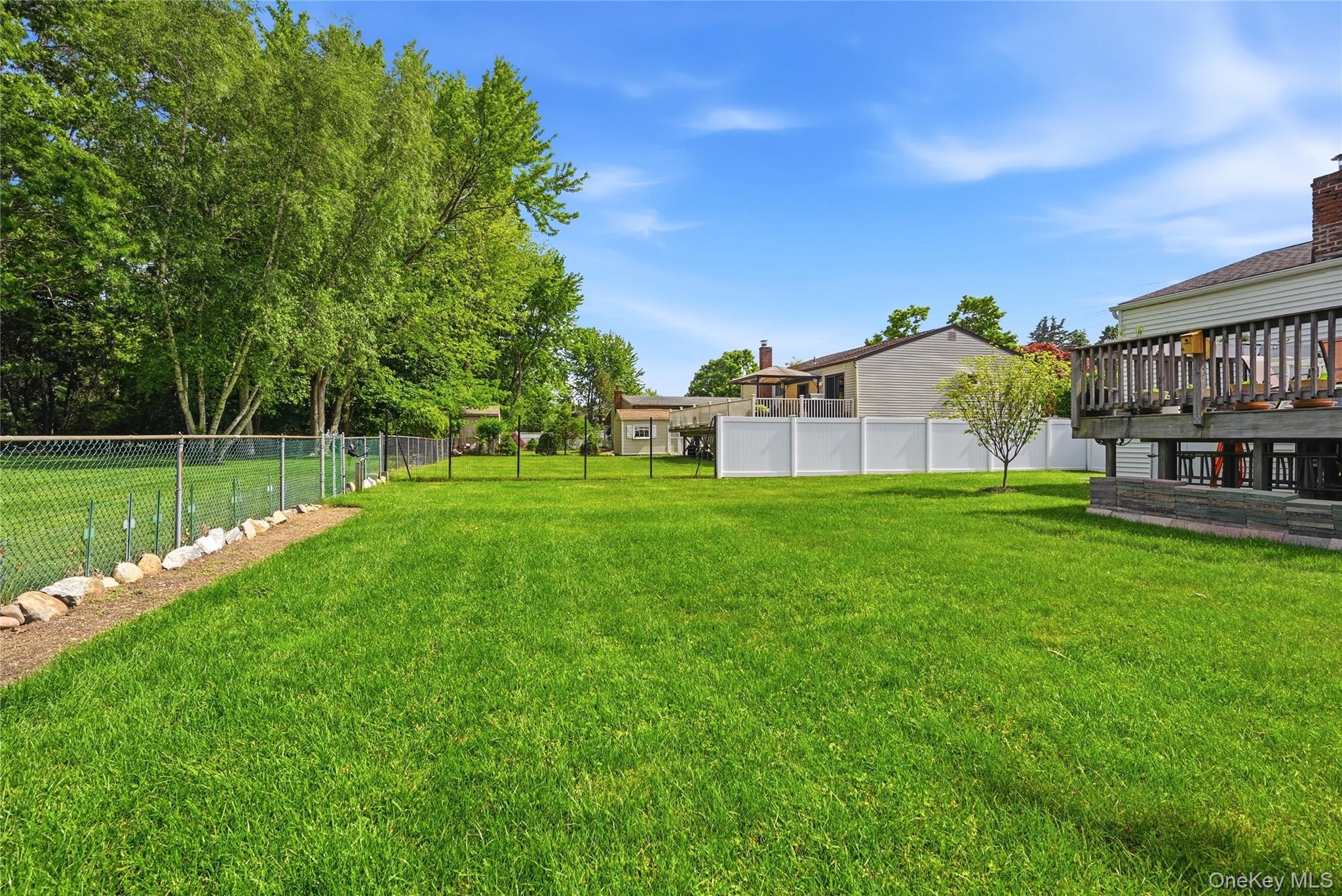 35 Randall Road Shoreham, NY 11786 - Photo 26 of 32 a view of a house with a big yard and large trees