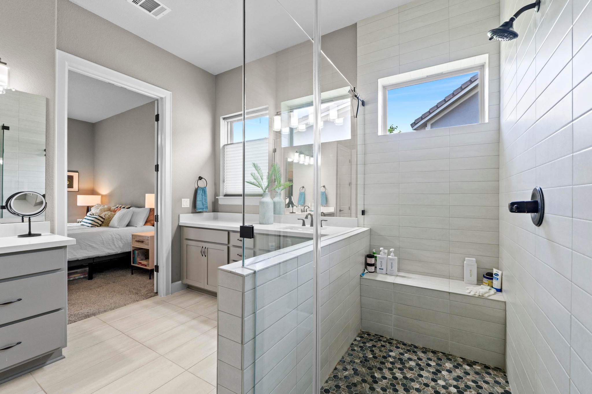 2609 Antalya Loop Leander, TX 78641 - Photo 18 of 40 a bathroom with a double vanity sink a mirror and a bathtub