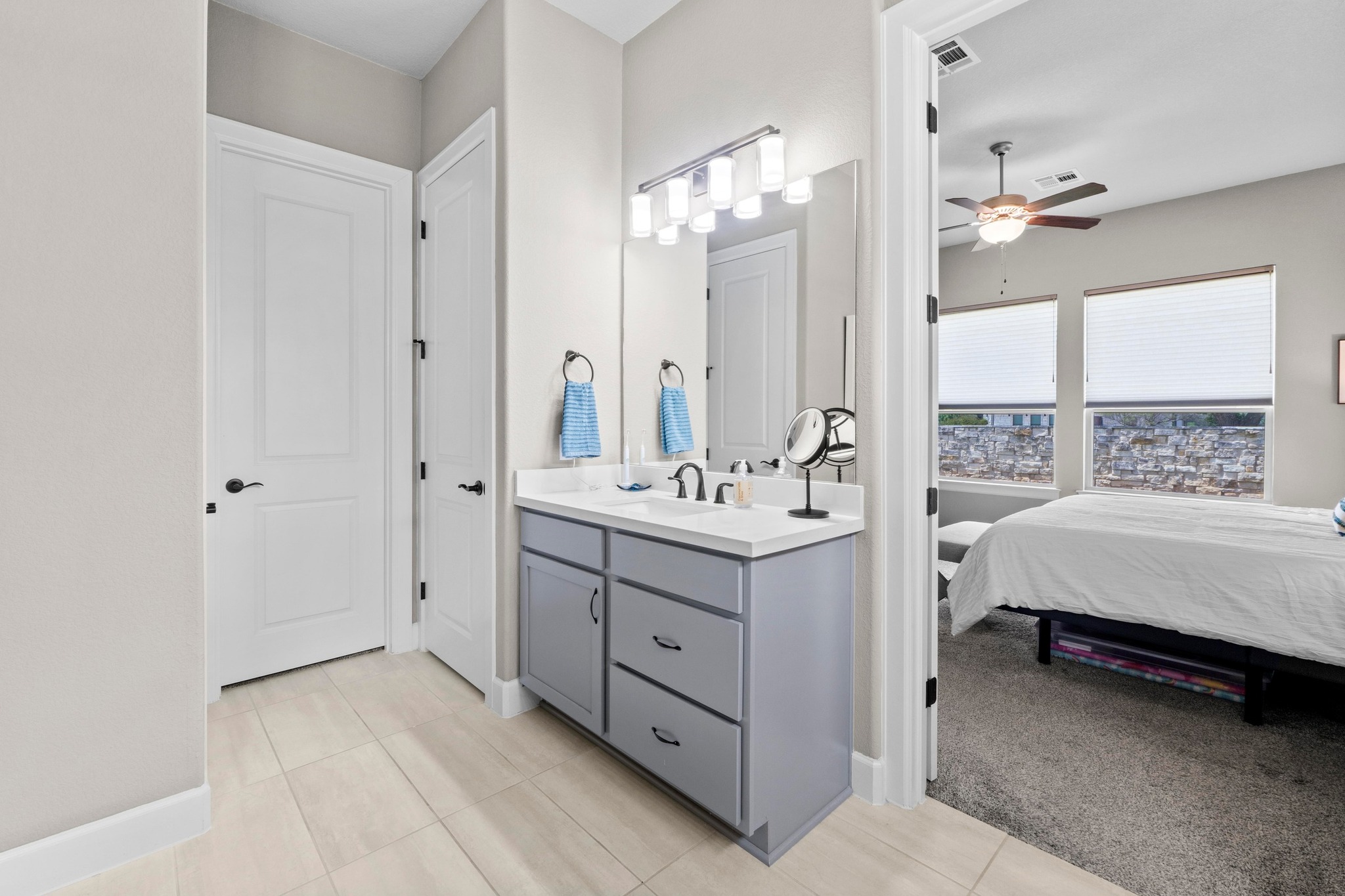 2609 Antalya Loop Leander, TX 78641 - Photo 19 of 40 a bathroom with a double vanity sink a mirror and a shower