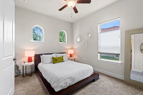 a bathroom with a toilet sink vanity and mirror