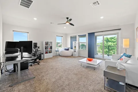 a living room with furniture and kitchen view