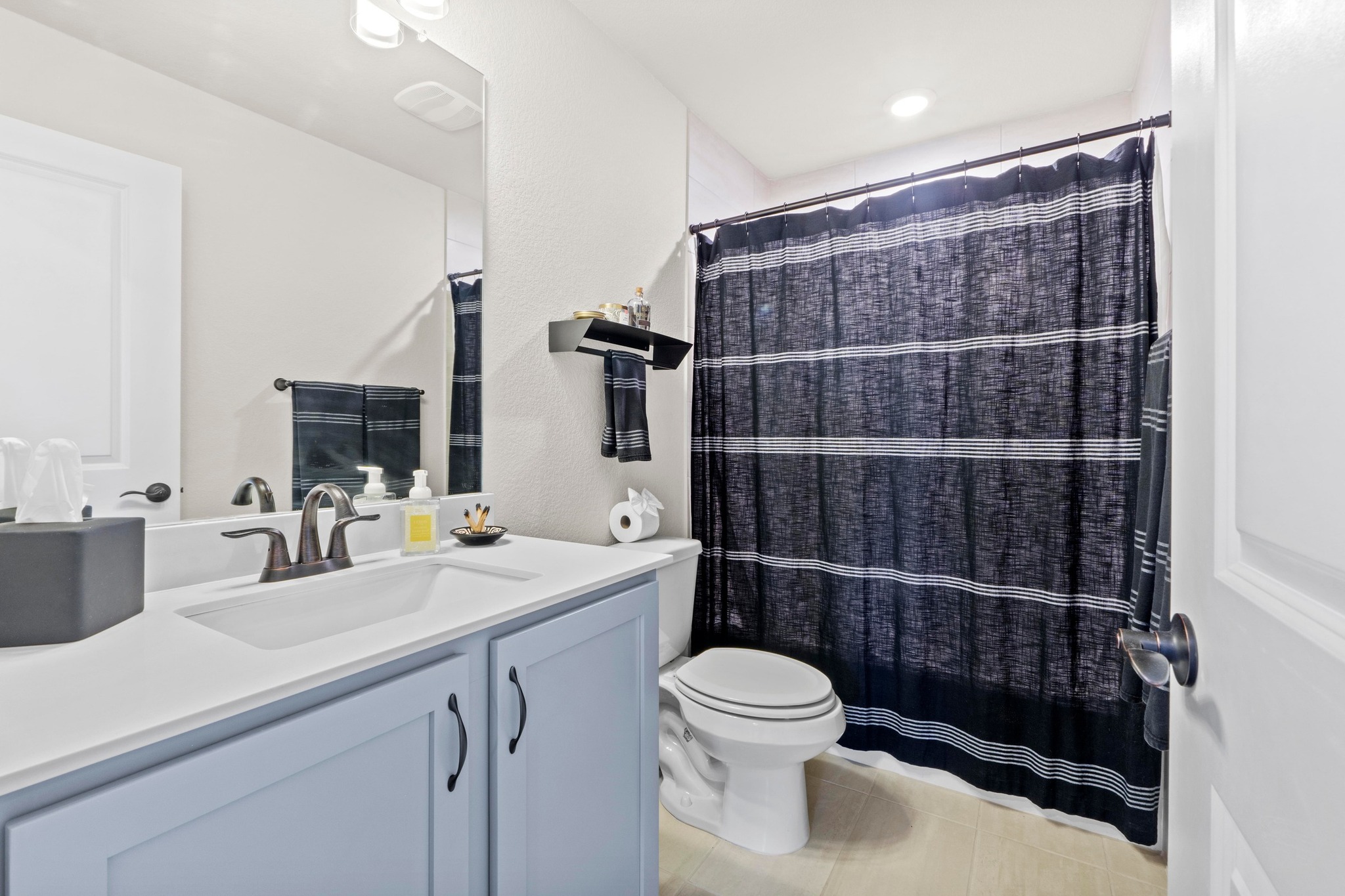 2609 Antalya Loop Leander, TX 78641 - Photo 27 of 40 a bathroom with a toilet a sink and a mirror