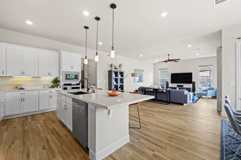 a kitchen that has a lot of cabinets in it and white cabinets