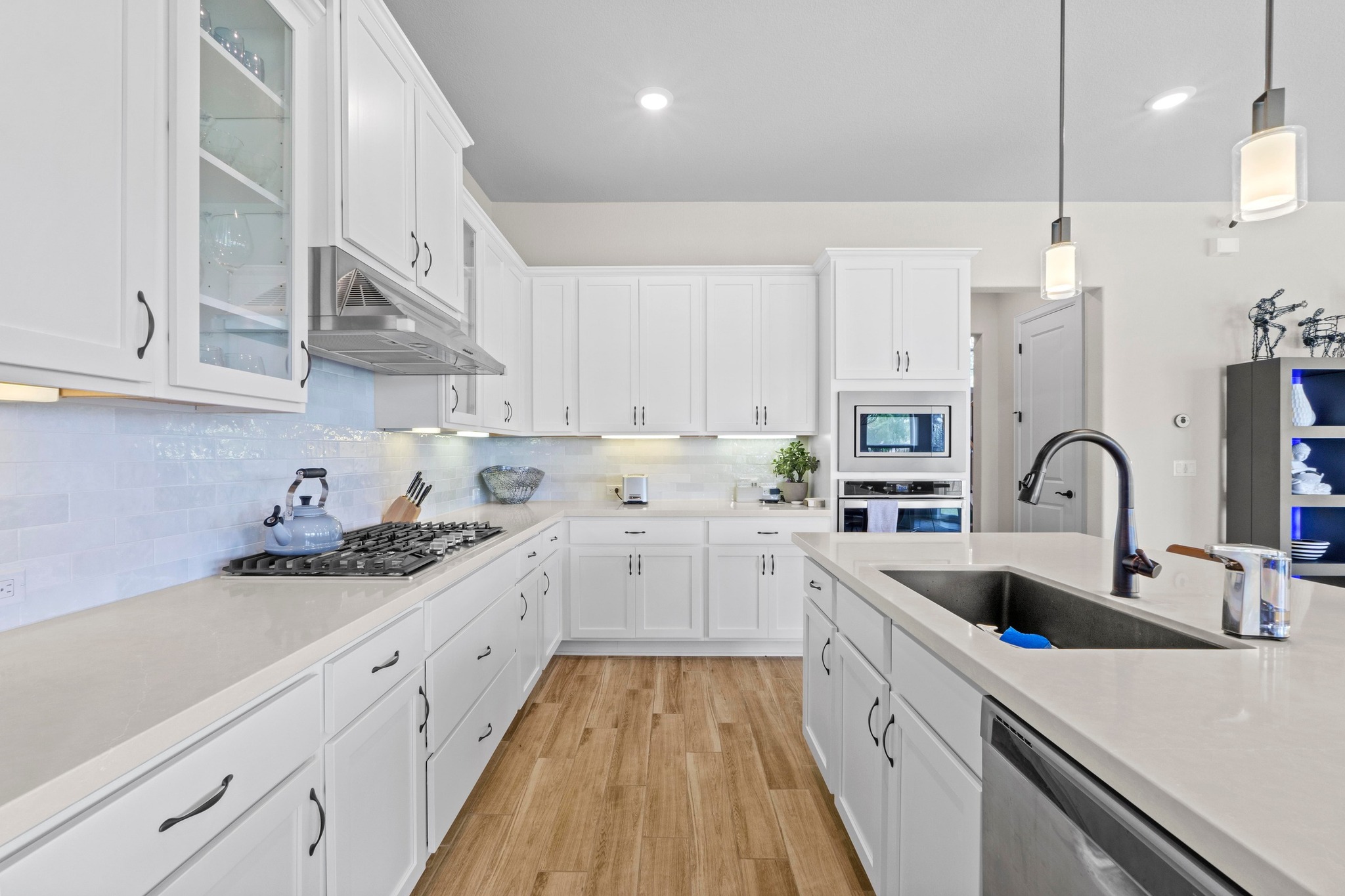2609 Antalya Loop Leander, TX 78641 - Photo 6 of 40 a kitchen that has a lot of cabinets in it and white cabinets