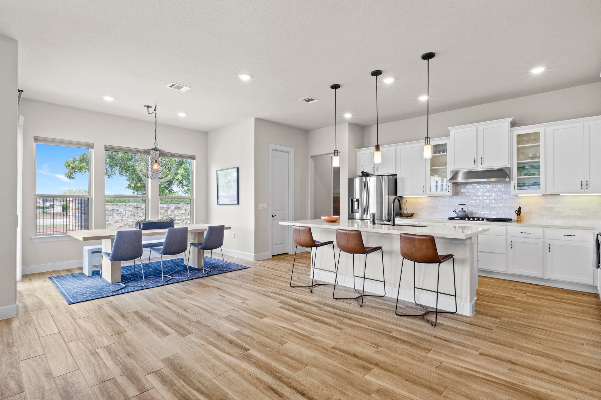2609 Antalya Loop Leander, TX 78641 - Photo 8 of 40 a living room with kitchen island furniture and a wooden floor