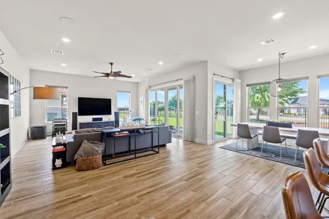 a living room with furniture a large window and a flat screen tv