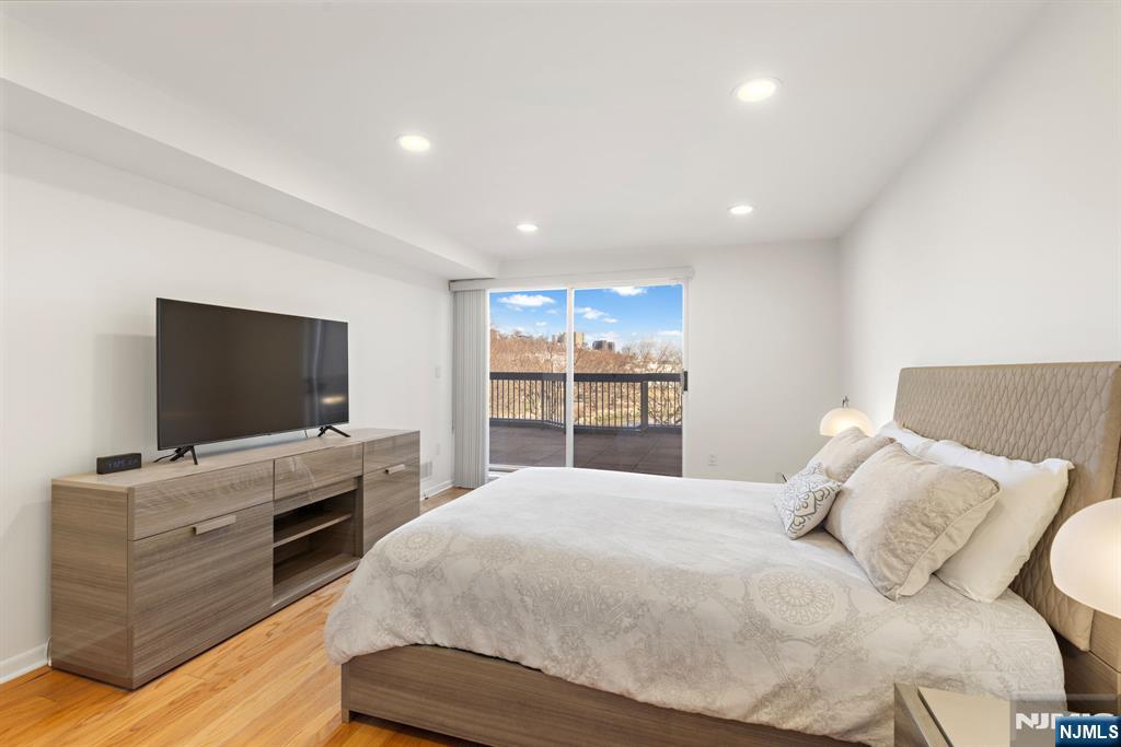 316 Nelson Court Edgewater, NJ 07020 - Photo 14 of 29 a bedroom with a large bed and a flat screen tv