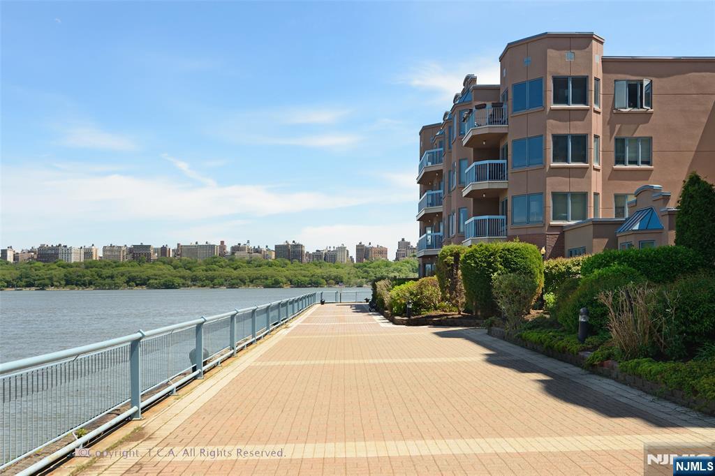 316 Nelson Court Edgewater, NJ 07020 - Photo 24 of 29 a view of a lake with a building in the background