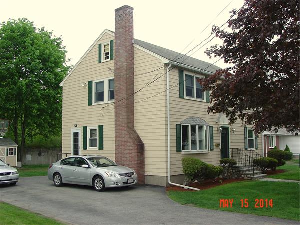 43 Johnson Road Arlington, MA 02474 - Photo 1 of 13 a front view of a house with a garden and parking
