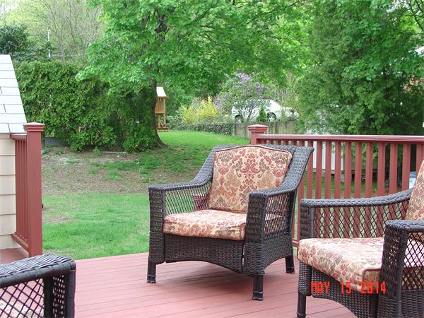 43 Johnson Road Arlington, MA 02474 - Photo 3 of 13 a view of a deck with a table and chairs with wooden fence