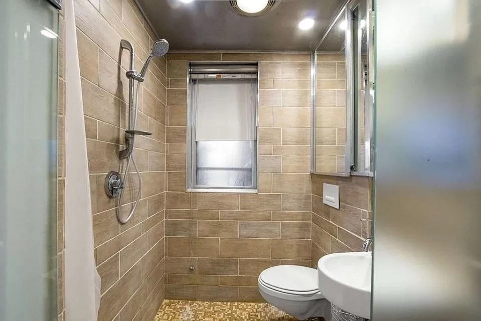 583 Massachusetts Avenue, Unit 5 Boston, MA 02118 - Photo 12 of 15 a bathroom with a toilet and a shower