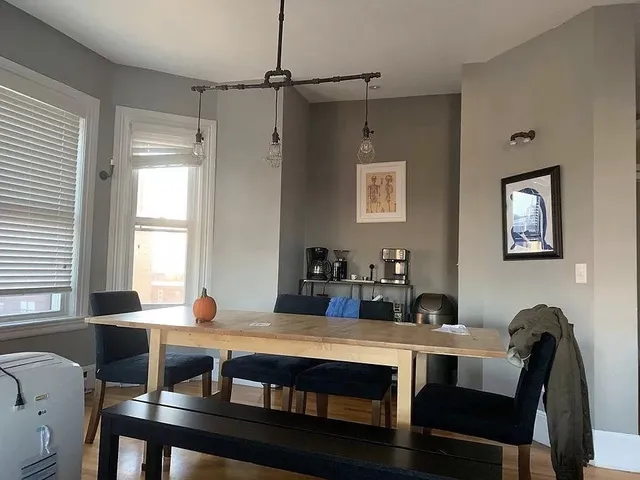 a view of a dining room with furniture window and wooden floor