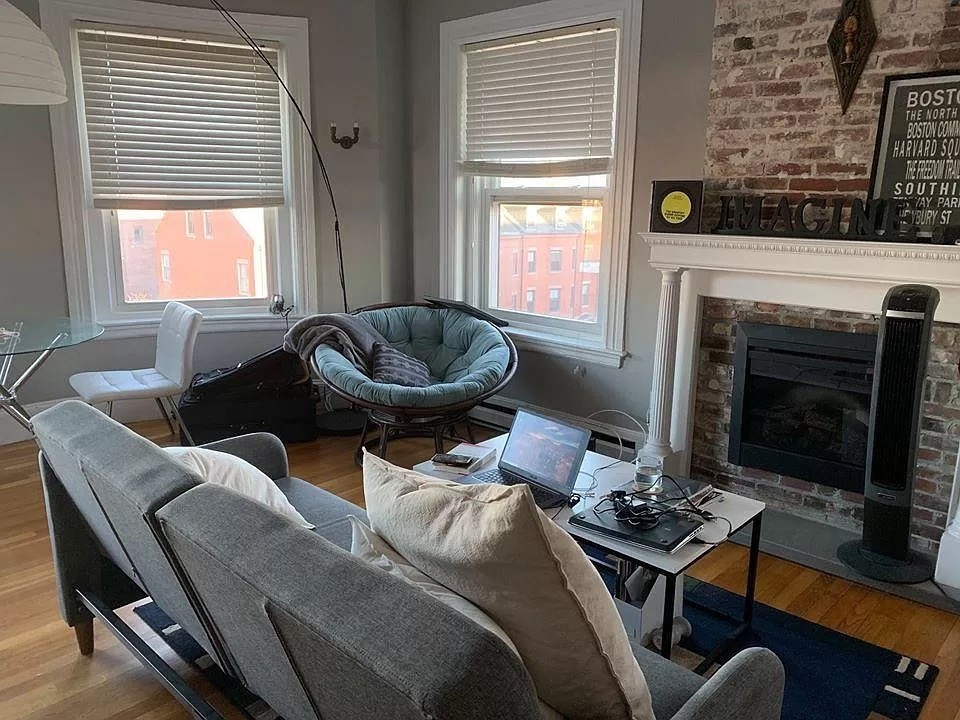 583 Massachusetts Avenue, Unit 5 Boston, MA 02118 - Photo 15 of 15 a living room with furniture a fireplace and a floor to ceiling window