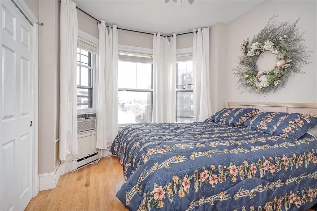 583 Massachusetts Avenue, Unit 5 Boston, MA 02118 - Photo 4 of 15 a bedroom with a large bed and a window