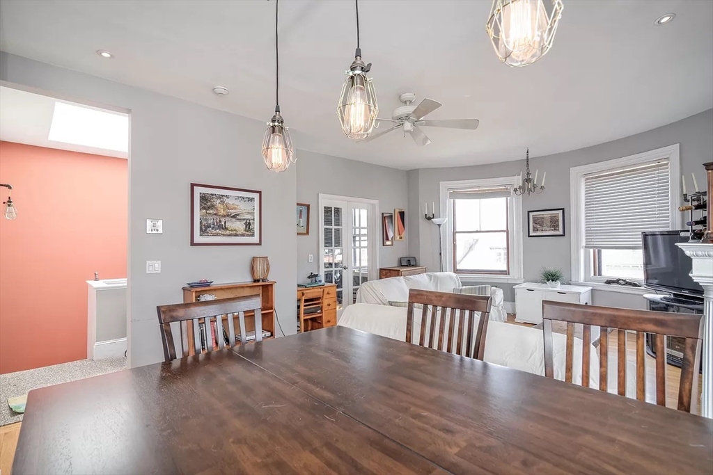 583 Massachusetts Avenue, Unit 5 Boston, MA 02118 - Photo 5 of 15 a view of a dining room with furniture a chandelier and wooden floor