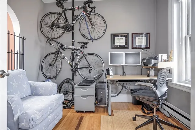 a living room with furniture a clock and a window