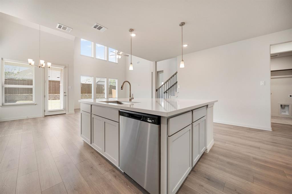 912 Alberta Spruce Road Justin, TX 76247 - Photo 12 of 35 a kitchen with counter top space and wooden floor