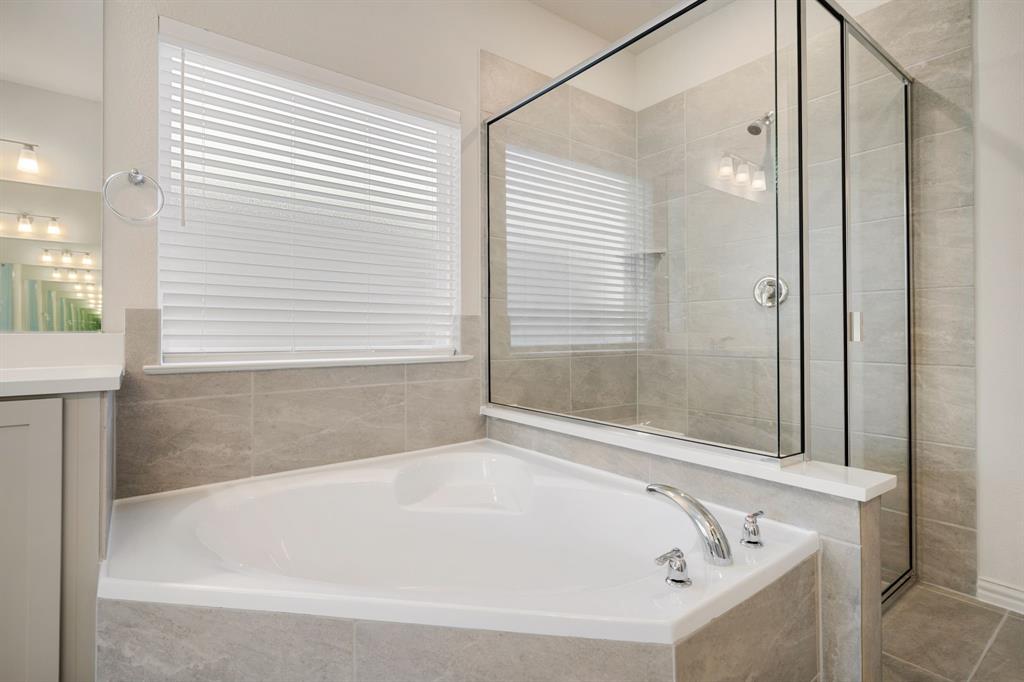 912 Alberta Spruce Road Justin, TX 76247 - Photo 20 of 35 a white bath tub sitting next to a shower