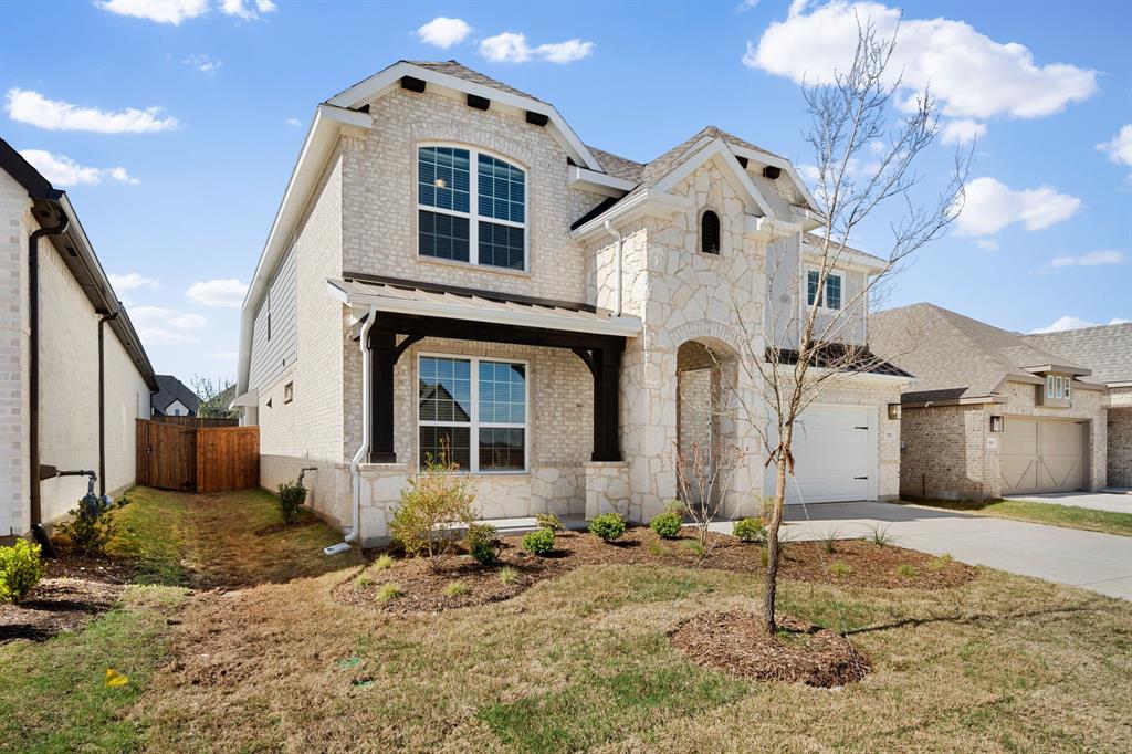 912 Alberta Spruce Road Justin, TX 76247 - Photo 2 of 35 a front view of a house with a yard