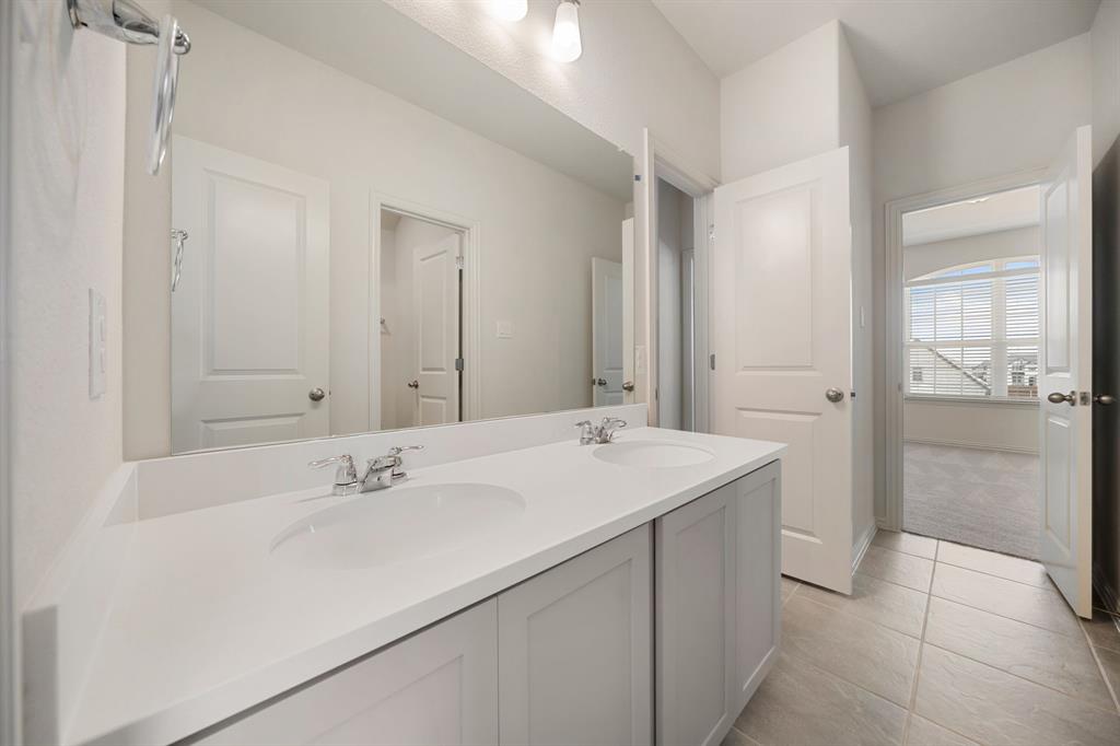 912 Alberta Spruce Road Justin, TX 76247 - Photo 28 of 35 a bathroom with a sink and a mirror