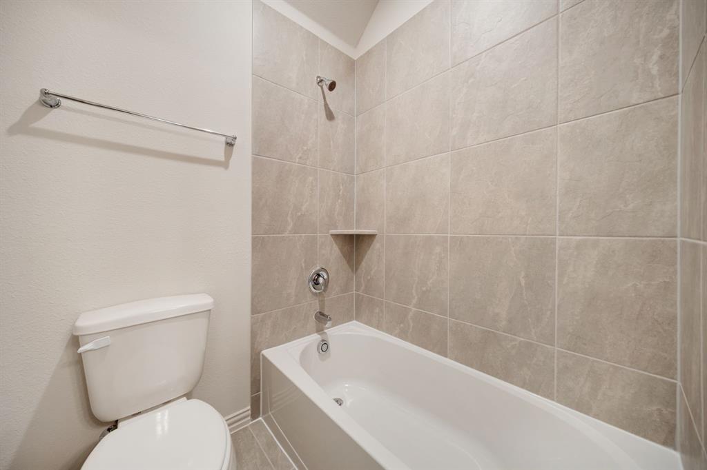 912 Alberta Spruce Road Justin, TX 76247 - Photo 29 of 35 a white toilet sitting next to a bath tub