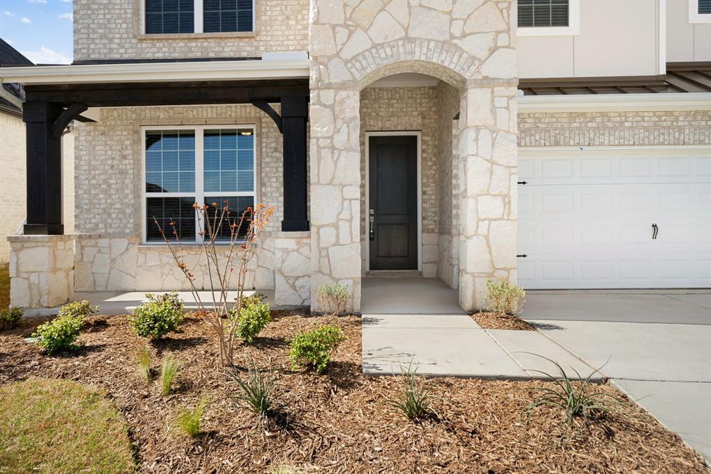912 Alberta Spruce Road Justin, TX 76247 - Photo 5 of 35 a front view of a house with a yard