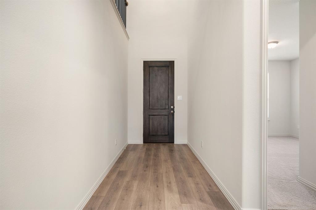 912 Alberta Spruce Road Justin, TX 76247 - Photo 6 of 35 a view of a hallway with wooden floor